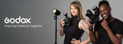 Two people holding camera equipment with Godox logo and tagline on a gray background