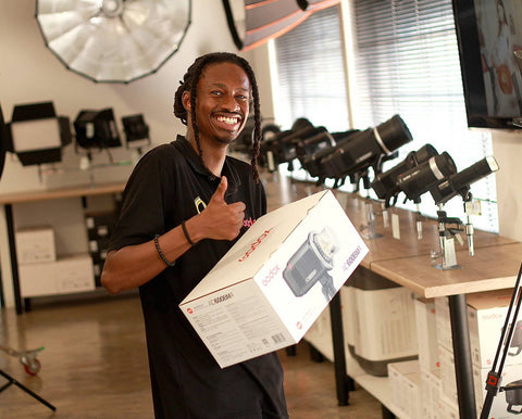 Lesedi holding a Godox AD600BmII at CameraStuff Walk-In Shop